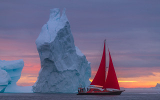 Red sailboat iceberg sunset ocean - an iceberg free wallpaper