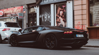 Black sports car parked white - the side of the road next free wallpaper