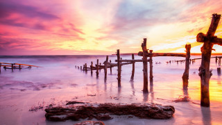 Sunset dock boat mountains sky - a sunset over a body of water free wallpaper