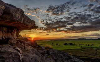 Sunset field rock formation tree - a sunset over a field free wallpaper