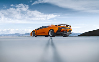Orange sports car mountains blue - nice looking orange sports car free wallpaper