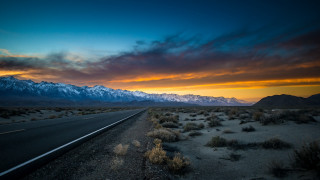 Sunset mountain road city lake - a mountain range in the background free wallpaper