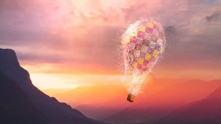 Hot air balloon sunset mountains - a sunset in the background and a mountain range in the foreground free wallpaper