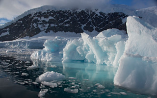 Icebergs mountains snowy cloudy scene - a group of icebergs free wallpaper