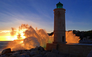 Lighthouse wave sunset ocean impressionist - volumetric light free wallpaper
