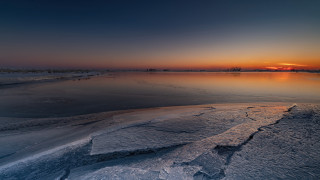Sunset frozen lake rocks trees - a sunset over a free wallpaper