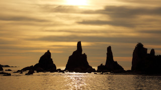 Rocks water sunset clouds mountain - a cloudy sky above them free wallpaper
