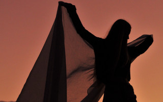 Woman scarf outstretched sunset silhouette - her hand behind her back free wallpaper