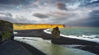 Black sand beach rock formation - free landscape wallpaper