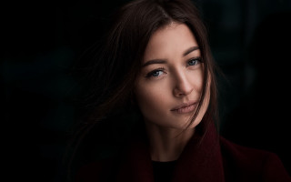 Woman red coat serious look - free portrait wallpaper for desktop