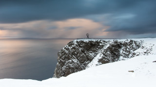 Cliff overlooking ocean surrealist sculpture - the ocean under a cloudy sky free wallpaper