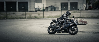 Motorcycle urban street fence building - a chain link fence free wallpaper