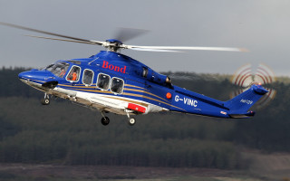 Blue helicopter forest cloudy day - free airplane wallpaper