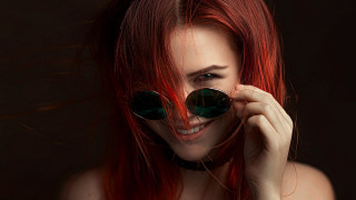 Red hair sunglasses smile portrait - a black background behind her free wallpaper for desktop