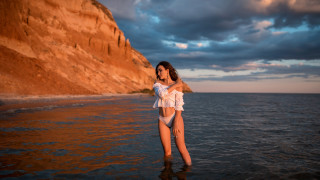 Woman bikini cliff water sunset - a cliff in the background free wallpaper