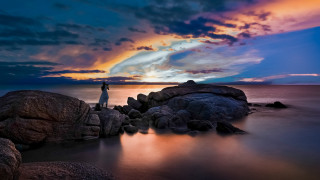Mystical sunset rock water cloudy - a cloudy sky above them free wallpaper