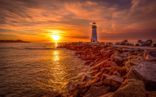 Lighthouse rocky shore sunset clouds 6 - a rocky shore free wallpaper