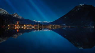 Lake mountain city night lights - light ray free wallpaper