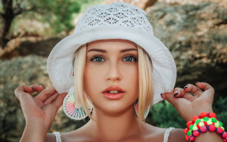 Blonde woman white hat bracelets - her hand and a tree in the background free wallpaper