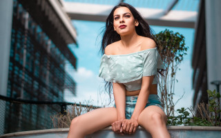 Woman cityscape metal sitting denim - a sky background and a building in the background free wallpaper