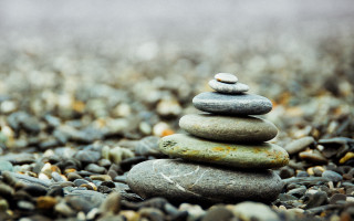 Stacked rocks gravel bokeh symmetric - a stack of rocks free wallpaper