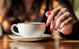 Woman hand coffee blurry background - a womans hand free wallpaper