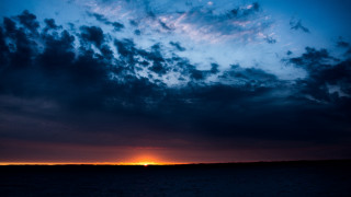 Sunset clouds boat water horizon - free sunset wallpaper