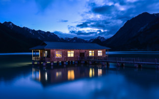 Wooden cabin lake night mountains - top of a lake under a cloudy sky free wallpaper for desktop