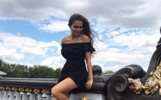 Woman black dress leaning railing - her leg up free wallpaper