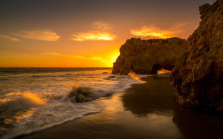 Sunset beach waves rock formation 2 - a sunset over a beach free wallpaper