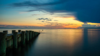 Pier lake sunset clouds bird - top of a lake under a cloudy sky free wallpaper