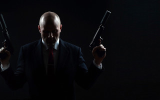 Man in suit holding guns - dirk crabeth free wallpaper