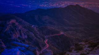 Mountain road night city lights - winding free wallpaper