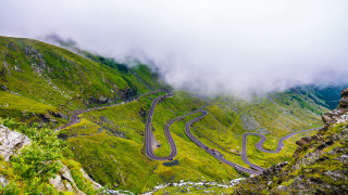 Winding road mountains cloudy sky - a few car free wallpaper