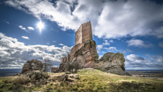 Rock formation sun clouds grass - a grassy area in the foreground free wallpaper