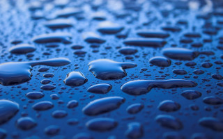 Water droplets blue surface sky 2 - a close up of water droplets free wallpaper