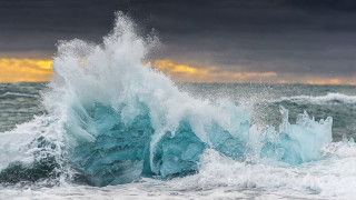 Wave iceberg ocean clouds sunset - a large wave free wallpaper