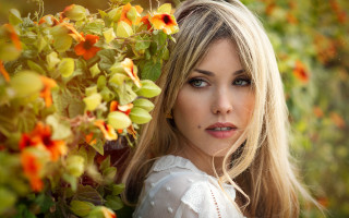 Blonde haired blue eyed woman 3 - a picture in a field of flowers free wallpaper