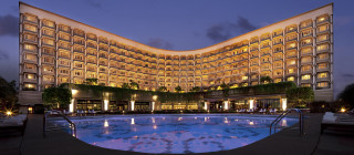 Large hotel night pool lights - a large building in the background free wallpaper for desktop