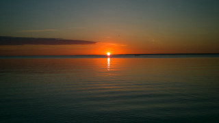 Sunset water boat clouds horizon 7 - a boat in the distance free wallpaper
