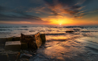 Sunset ocean wood beach puzzle - a large body of water free wallpaper