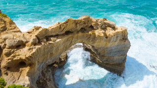 Rock formation water cliff beach - a large rock formation free wallpaper