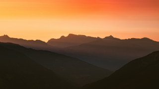 Bird mountain sunset clouds nature - over a mountain range free wallpaper