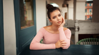 Woman serious portrait bookshelf blurry - a woman sitting free wallpaper