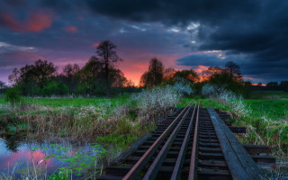 Sunset train track grassy field - a train track free wallpaper
