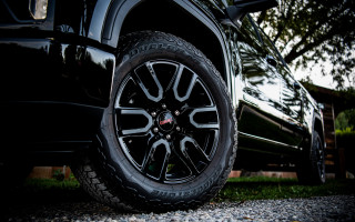 Black truck tire trees building - the background and a building in the background free wallpaper