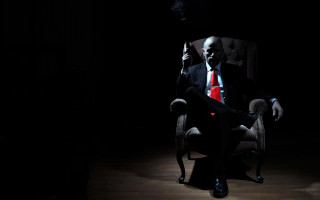 Man suit smoking dark room - david begbie free wallpaper