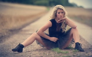 Woman sitting on tire outdoors - a tire free wallpaper