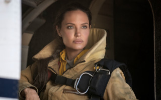 Woman yellow jacket window camera - feminist art free wallpaper