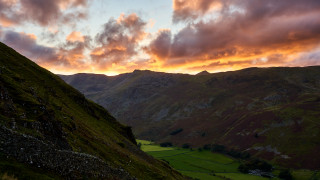 Mountain grassyfield sunset clouds cityscape - dramatic light free wallpaper for desktop